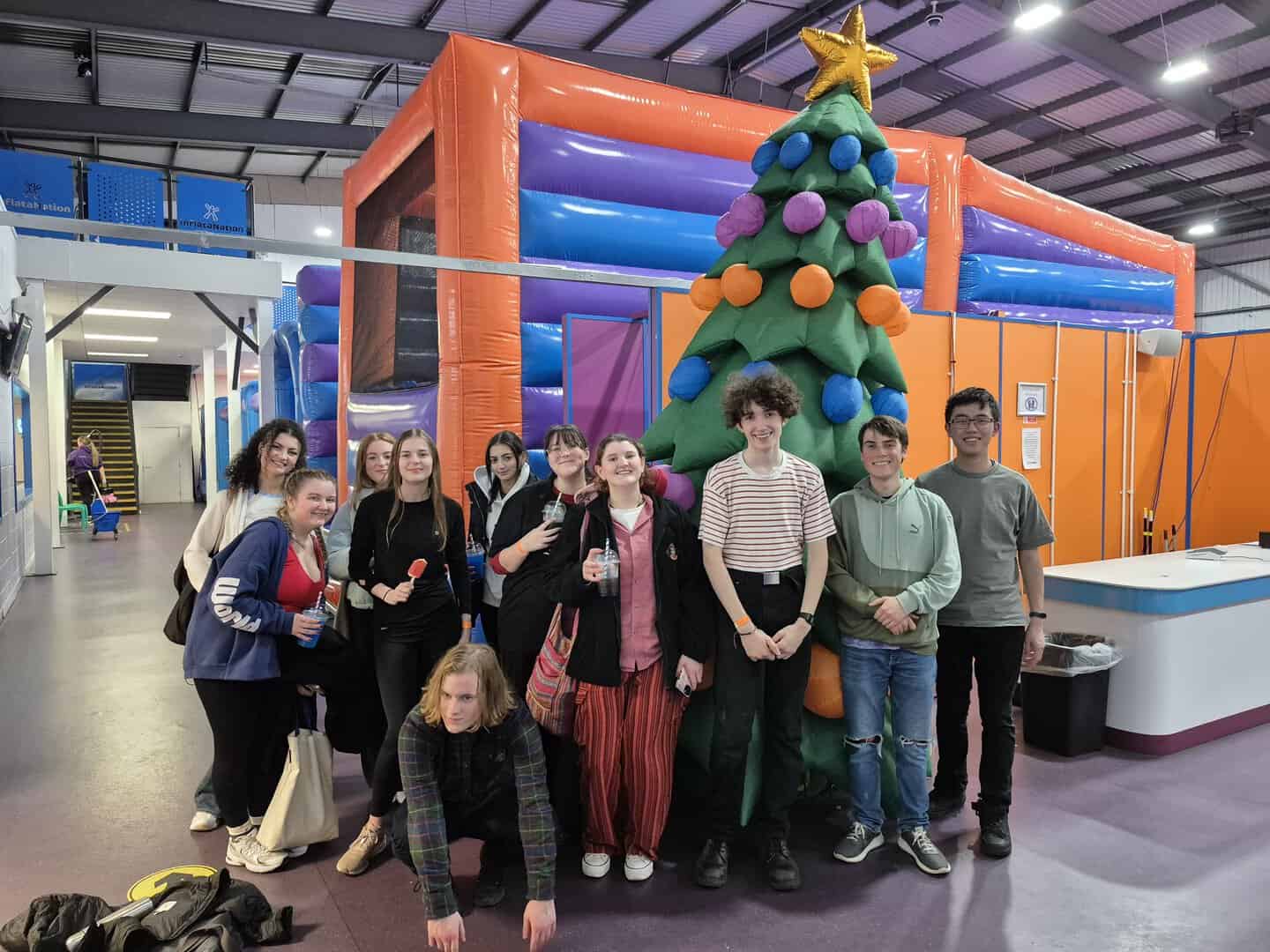 CAOS stood in front of inflatable and Christmas Tree